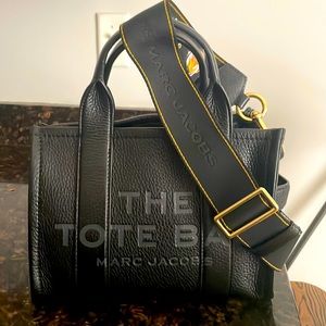 Marc Jacobs mini traveler Tote, black with gilded webbing strap.